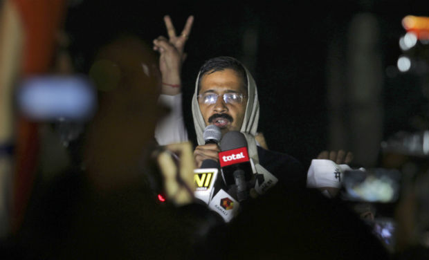 A supporter flashes a victory sign as Delhi CM Arvind Kejriwal, calls off the two-day protest against the police in the capital, on Tuesday. -AP A supporter flashes a victory sign as Delhi CM Arvind Kejriwal, calls off the two-day protest against the police in the capital, on Tuesday. -AP